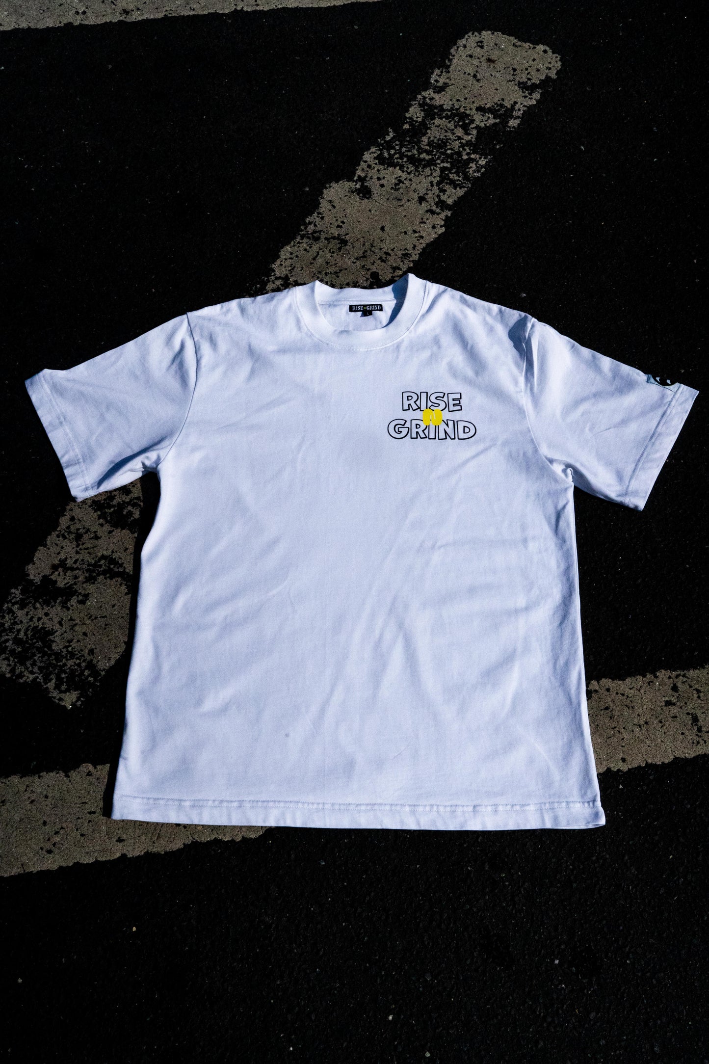 White t-shirt with a logo on a black textured background