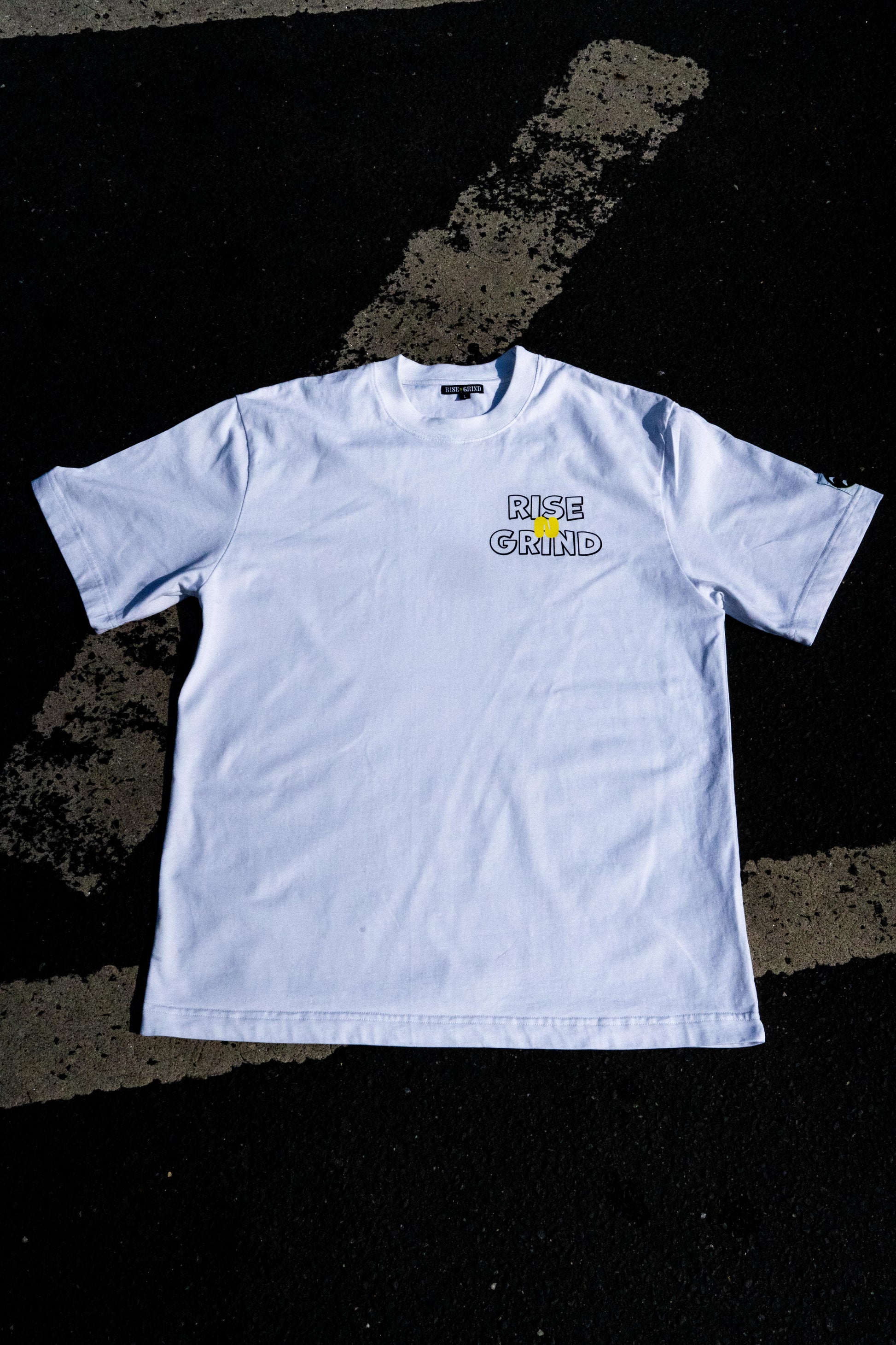 White t-shirt with a logo on a black textured background